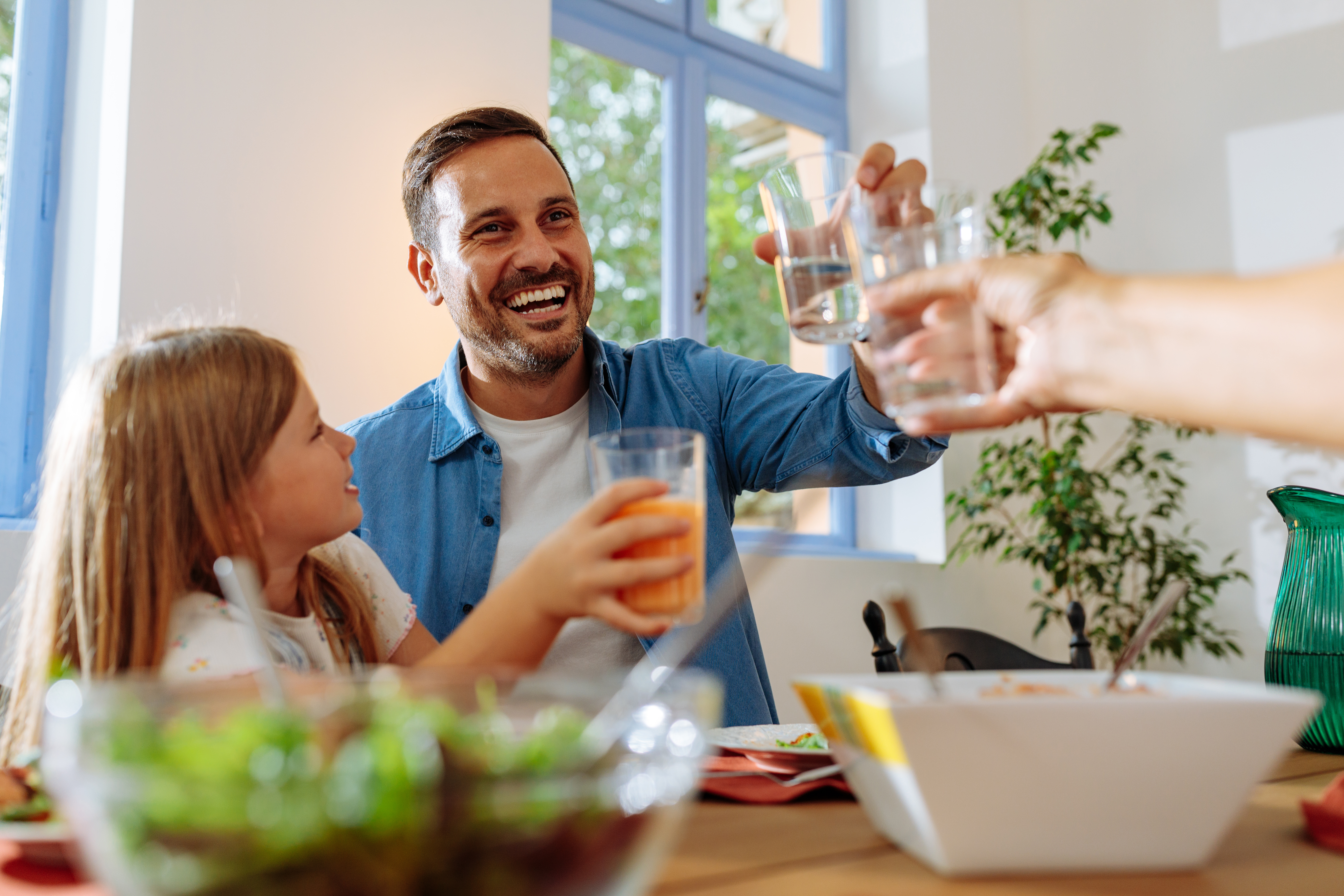 Happy family enjoying clean water together at the dinner table